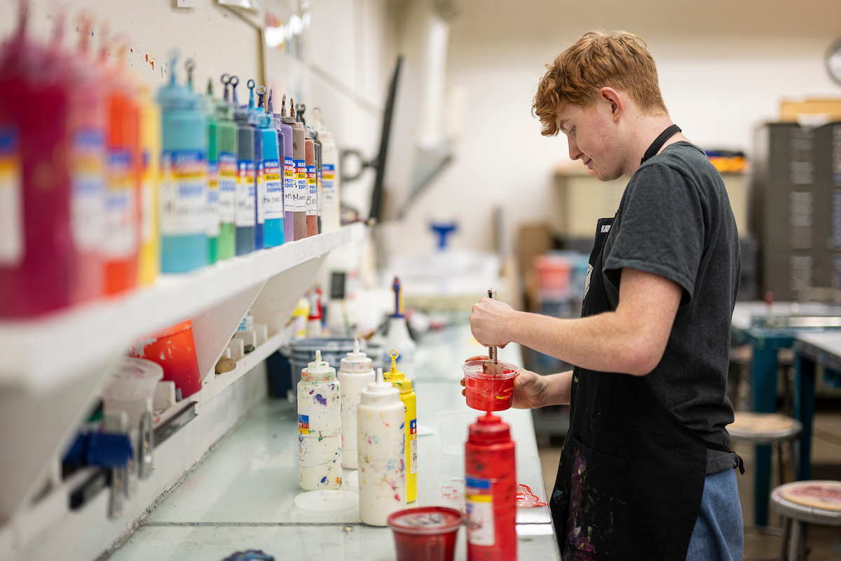 An individual in a printmaking lab